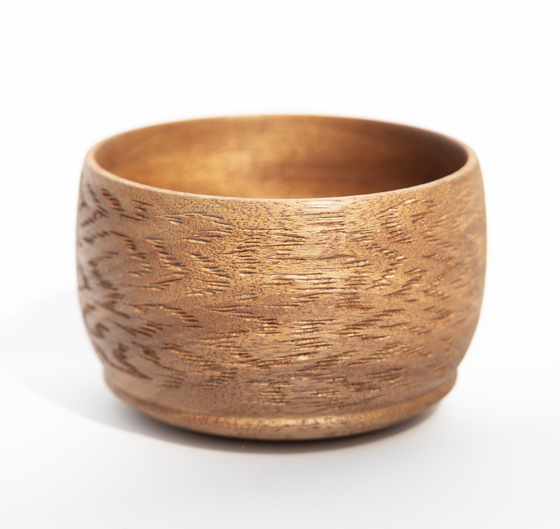 photograph of a bowl with carved patterns on the side
